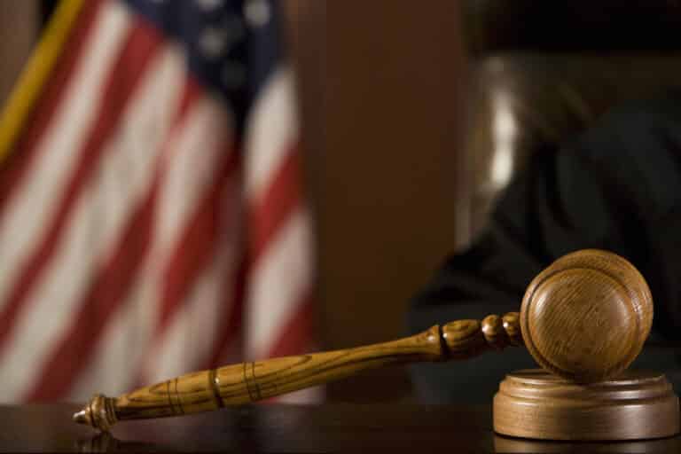 Gavel on desk, American flag in background