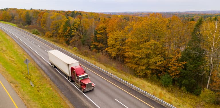 semi-truck overhead shot in autumn on highway
