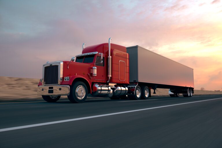 Semi-truck at sunset on highway