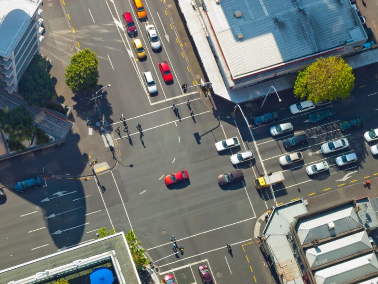 aerial shot of intersection with cars and pedestrians
