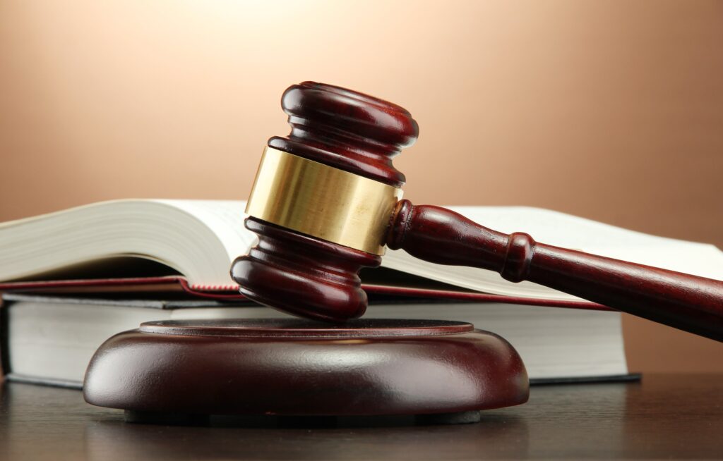 Gavel in front of books
