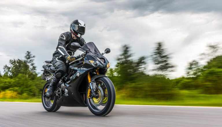 motorcycle rider riding on cloudy day