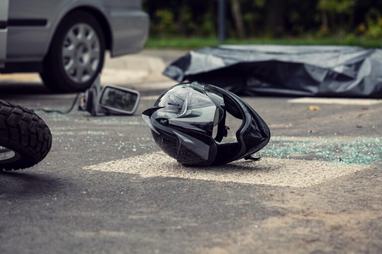 aftermath of motorcycle accident, helmet on road