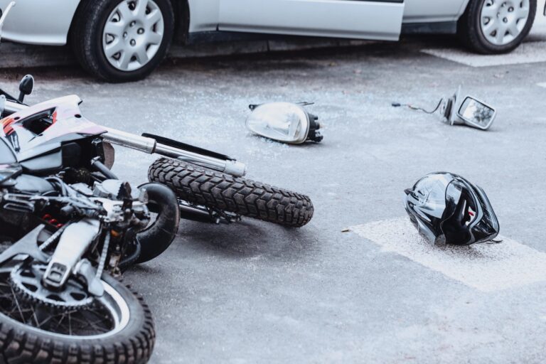 motorcycle and helmet on ground after crash