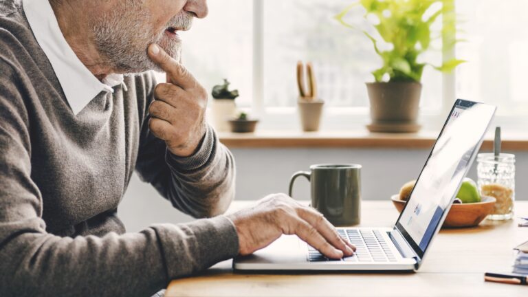 Older man looking at laptop