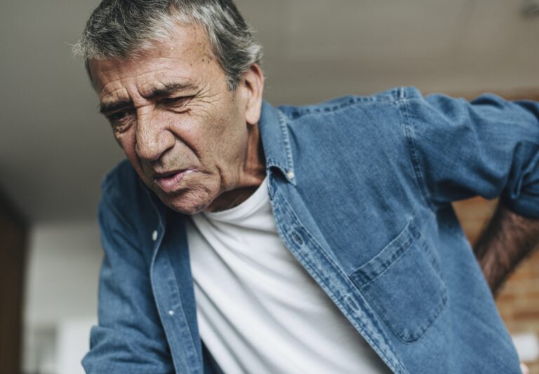 Older man holding back in pain