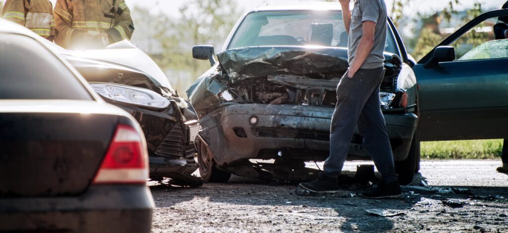 Aftermath of car accident, man talking on phone